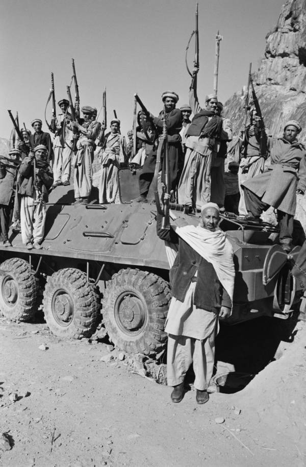 AFGHAN MUJHAIDEEN STANDING ON A CAPTURED SOVIET ARMORED VEHICLE
