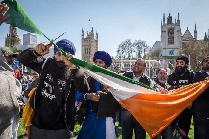 Sikhs Cutting filthy indian flag in uk